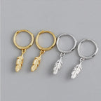 Hoop earrings with a small dangling feather