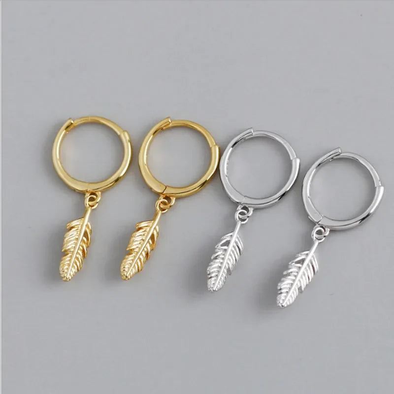Hoop earrings with a small dangling feather