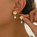 Boucles d'oreilles dorées coquillage et perle