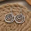 Boucles d'oreilles pendantes avec spirale ciselée