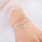 Gold-tone bracelet with small spiral charm