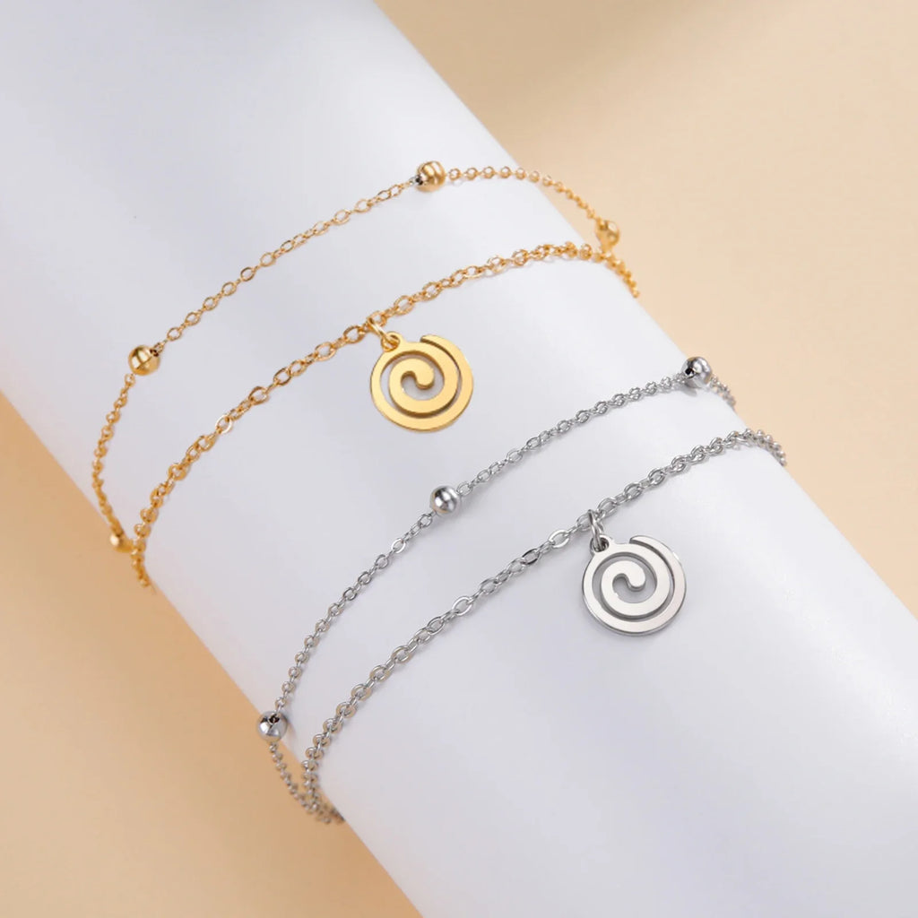 Bracelet doré avec petite breloque spirale or