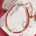 Bracelet rouge et doré corail