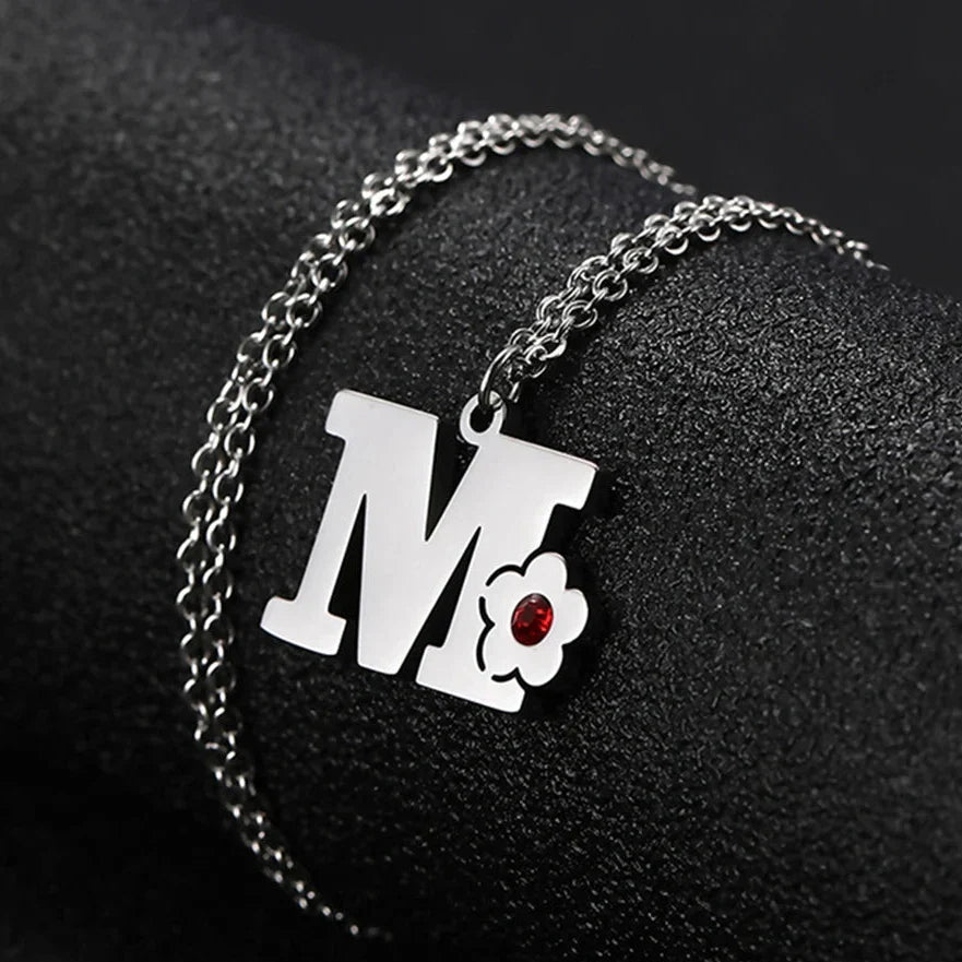 Necklace with flower pendant and initial letter