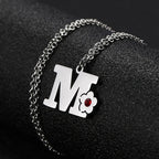 Necklace with flower pendant and initial letter