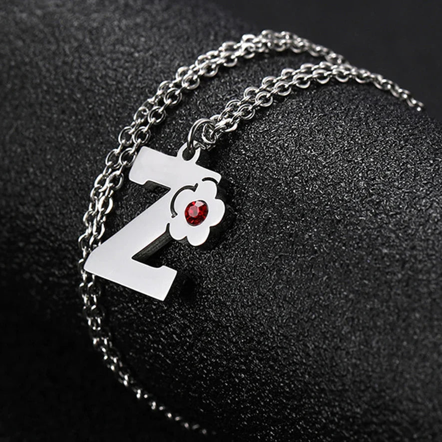 Necklace with flower pendant and initial letter