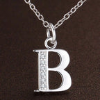 Necklace with initial letter pendant and rhinestones