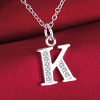 Necklace with initial letter pendant and rhinestones