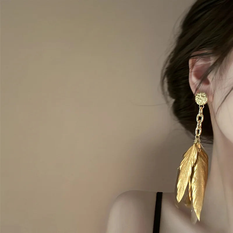 Grandes boucles d'oreilles plumes dorées