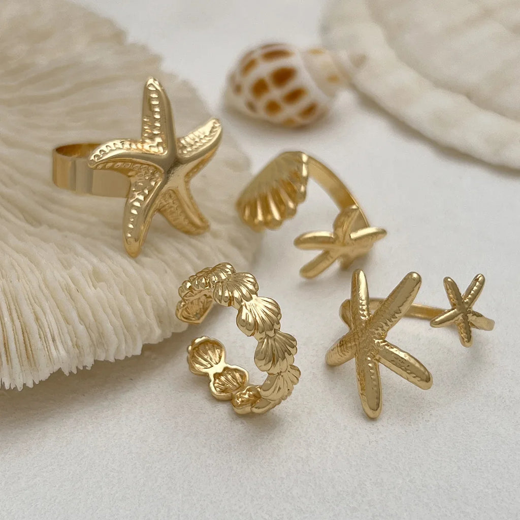 Lot de 4 bagues coquillage et étoiles de meror
